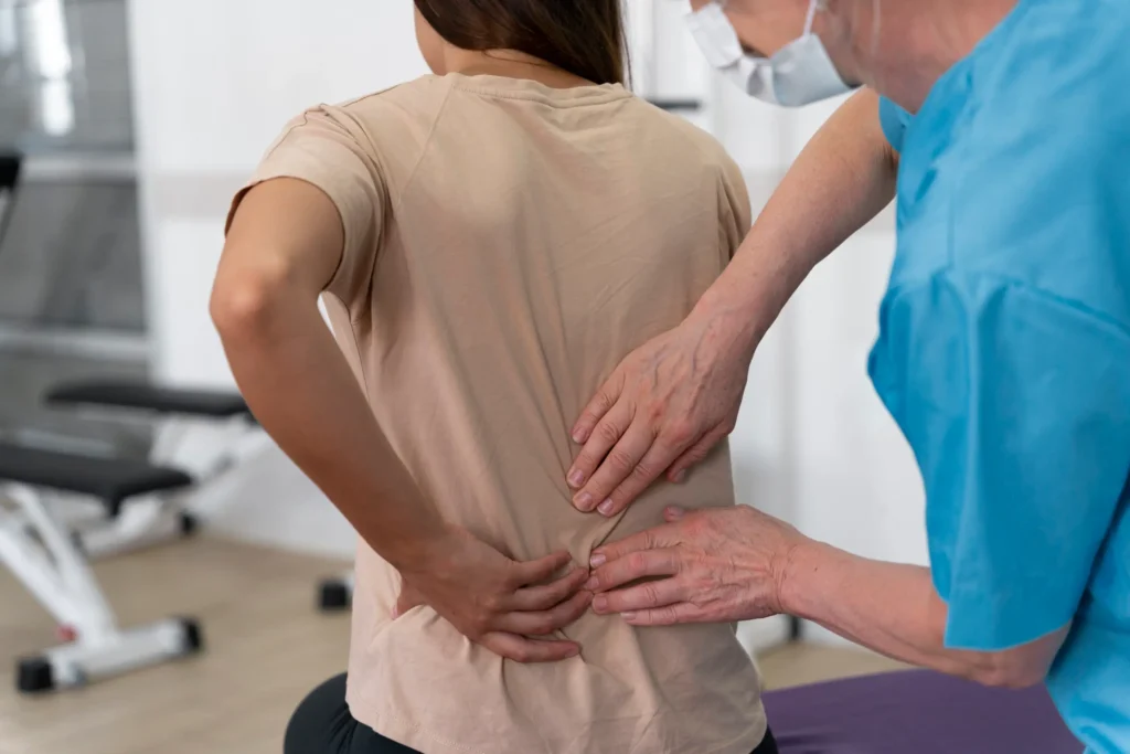 Doctor Examining Patient's Lower Back Pain