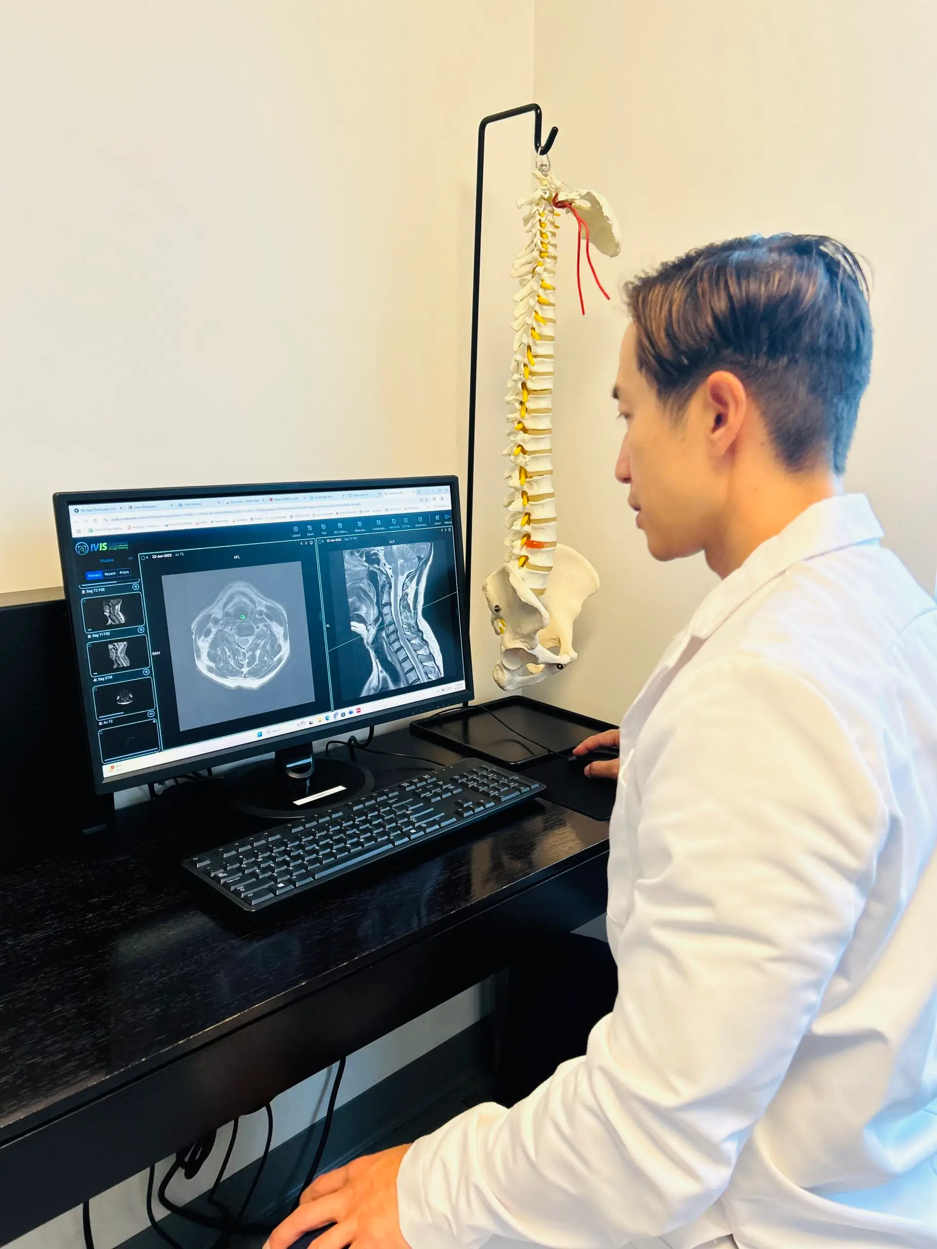 Dr. Albert P. Wong MD Reviewing Spinal Scans