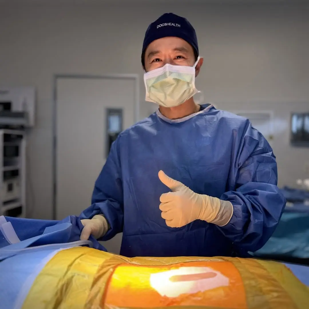 Dr. Albert P. Wong MD in Surgical Scrubs Giving a Thumbs Up